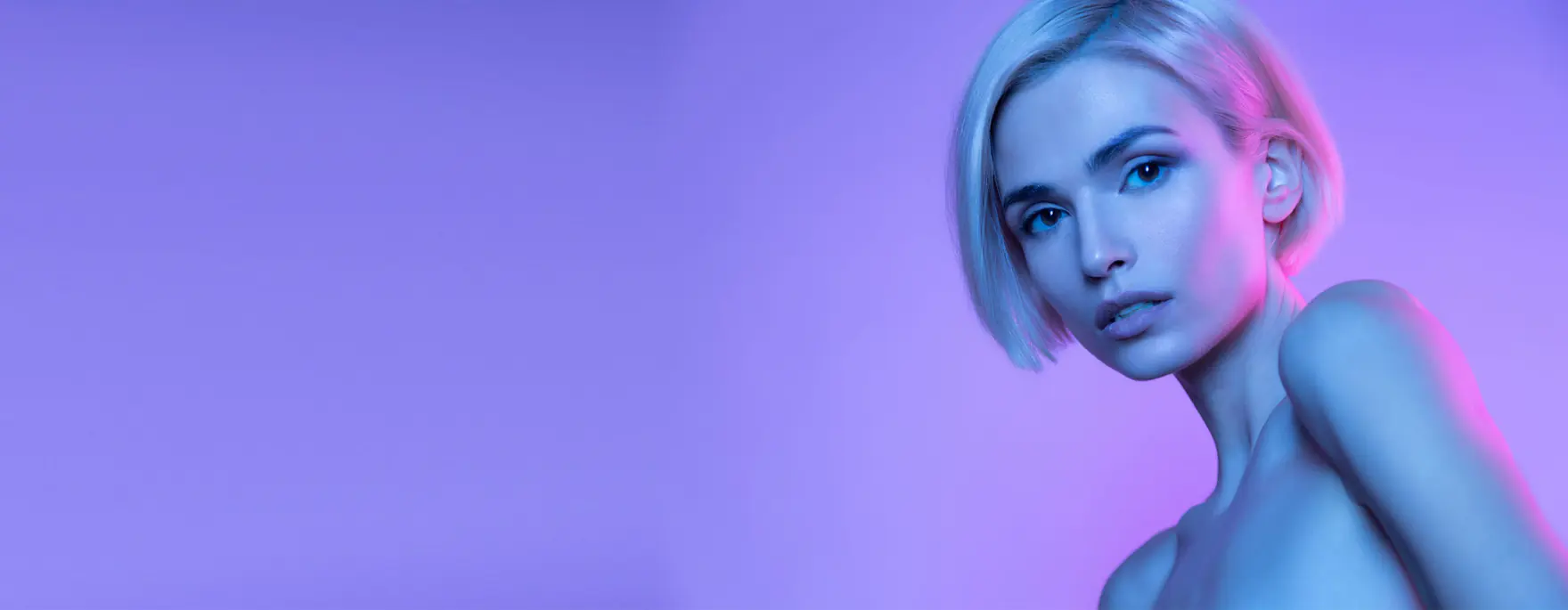 Studio portrait lit in purple and blue